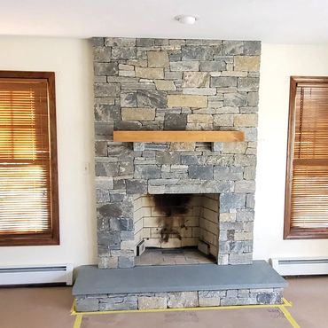 Bluestone hearth and solid 8" wood mantel installed for this new fireplace facelift