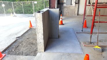 New concrete floor section is poured and the existing steel column is set