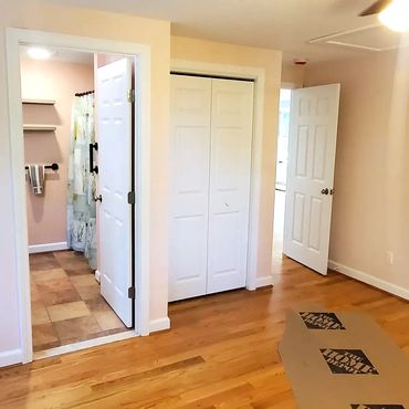 Hardwood floors with white doors, casings and baseboard for this new 900 soft home addition