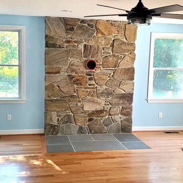 New England Field stone wood stove veneer and a bluestone flush hearth