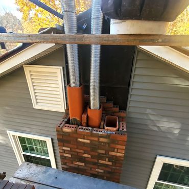 Chimney rebuild in progress. New building paper is installed up against the existing structure as a