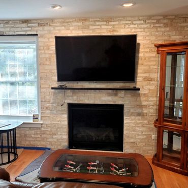 Brick veneer completed floor to ceiling with white mortar troweled off as a rough finish