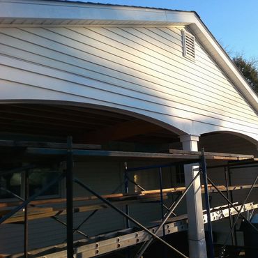 Carport and new addition is roofed and vinyl siding installed