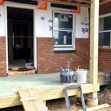 Reclaimed brick veneer on a farmers porch addition