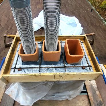 Chimney cap is formed and steel rebar installed for reinforcement. PVC flashing is laid and top of t