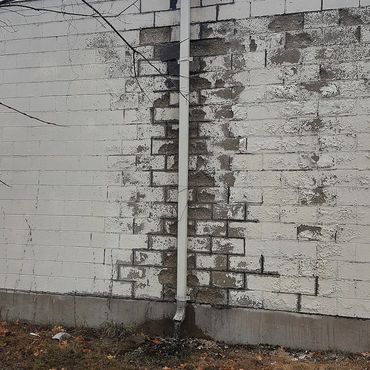Block building in Vernon Ct, block faces crumbling and deteriorated mortar joints allowing moisture