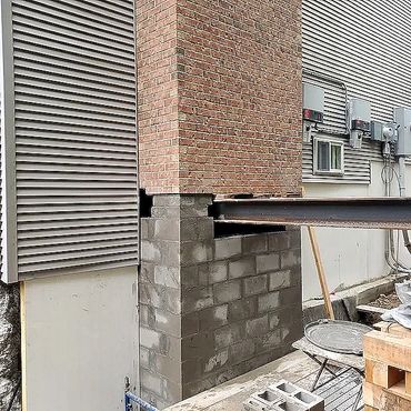 New block masonry foundation for an existing crumbling foundation fireplace chimney, ready for I-bea