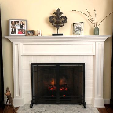 Painted brick fireplace with mosaic tile hearth