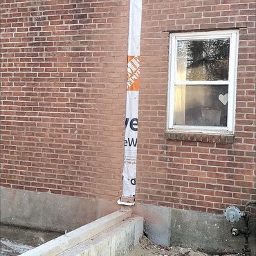 New vertical opening in the exterior brick veneer to accept the framing for the new addition