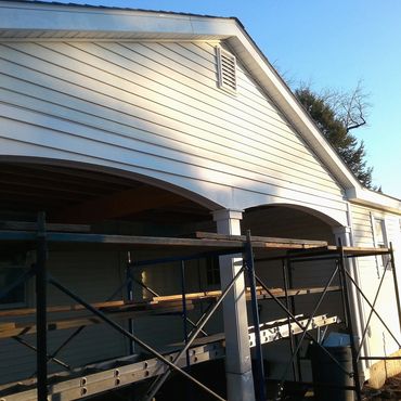 Carport and new addition is roofed and vinyl siding installed
