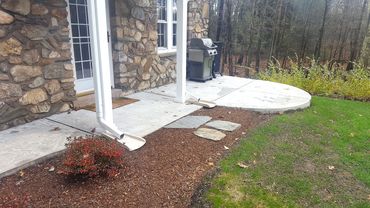 We removed the existing flag stone and poured a new concrete walkway and patio with a radius section