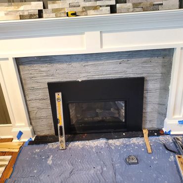 The new Fireplace insert along with the custom wood mantelpiece are installed