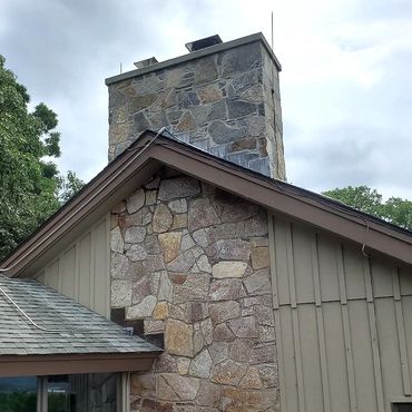 Finished stone chimney restoration from the roof up up