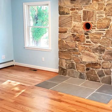 Wood stove stone veneer with large bluestone hearth & thimble