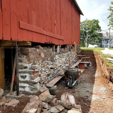 Stone foundation measures 2'6" at the bottom tapering to approximately 1'6" on the top. Red mortar i