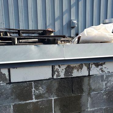 Mortar joints ground out and entire wall is power washed