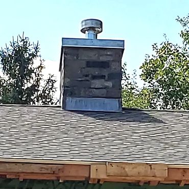 Thin stone gas fireplace chimney veneer with a custom chase cover