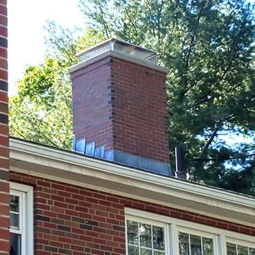 Commercial chimney project completed with lead flashing, a 4" concrete cap and a full size stainless