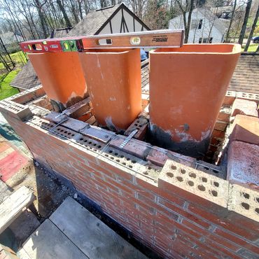 Proper way to rebuild the chimney, notice inner brick walls separating the flue liners and reinforce