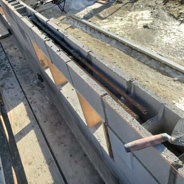 Bond beams are installed over the window openings. The finished windows will be glass block