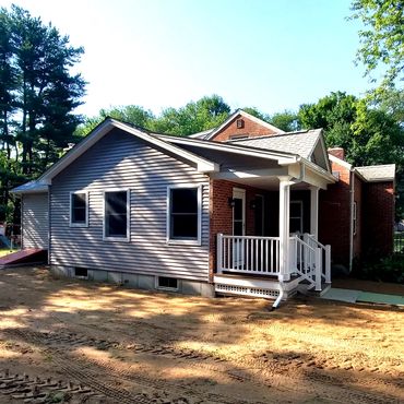 Side view of the new house addition with on site reclaimed used brick for the front porch veneer