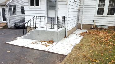 New steps, landing and walkway redone, existing railings modified and reinstalled