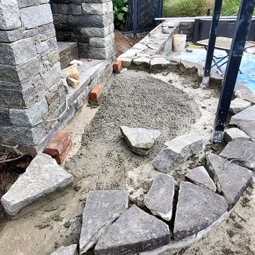 Stone is set in mortar for edge of semi-circular landing