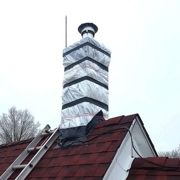 The leaking chimney is temporarily covered and waterproofed until the rebuild in the Spring