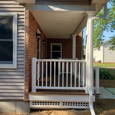 New addition front porch finished with a brick veneer, Trex decking and PVC railing