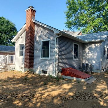 Wood stove brick chimney centered on the new living  room gable wall