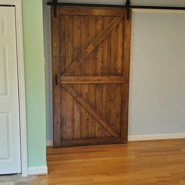 Stained Barnwood sliding door in this new farmhouse addition