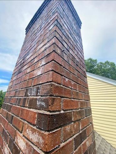 The sealing process, you can see the brick soaking up the sealer, this will protect this chimney fro