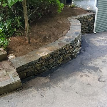 The stone capping in mortared in to stabilize then top of the new wall
