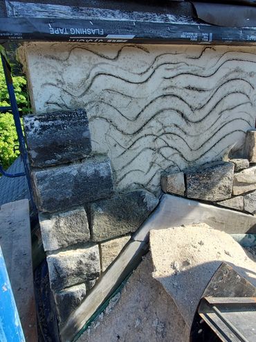 Plastered scratch coat accepts the new Thin stone
