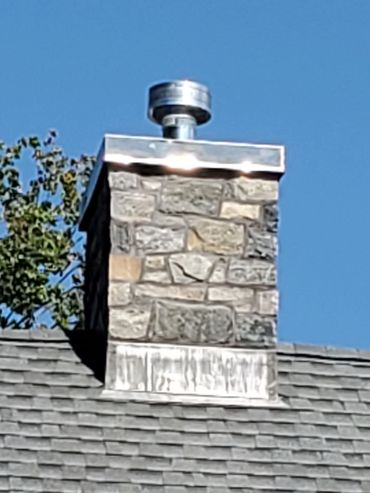 Stone matches the new roof , through flashing installed to prevent moisture infiltration