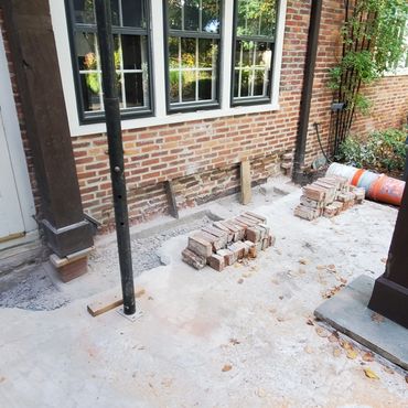 Wooden trellis is shored above