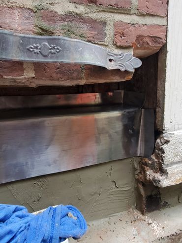 The inner brick leaf is plastered and a lead flashing pan is installed