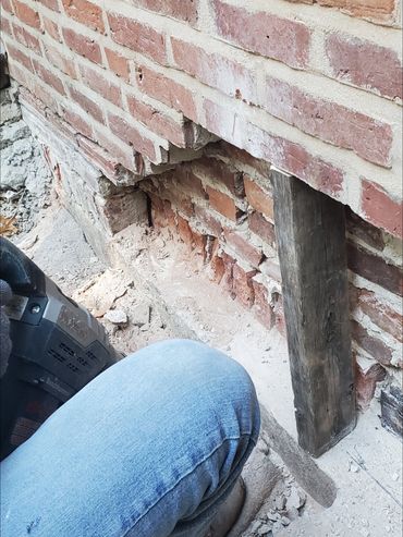 Upper brick courses are shored