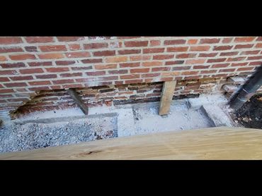 Foundation brick shelf is exposed
