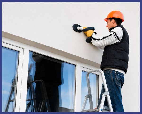 Worker sanding wall with focus