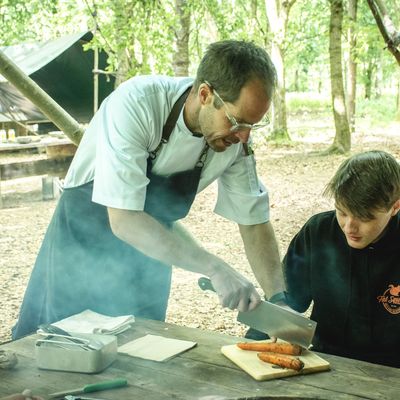 Specialist chef demonstrating how to use a knife to cut carrots at Fat Squirrel Outdoor