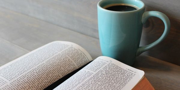 a coffee cup and a bible