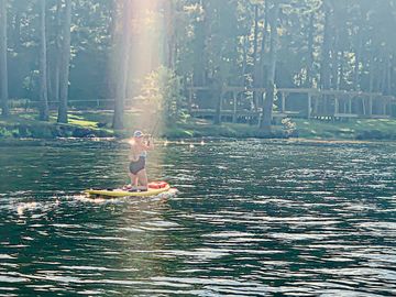 woman on paddle board on the lake water paddling 