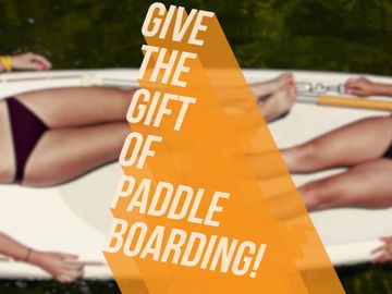 image of 2 girls laying on a paddle board and font saying give the gift of paddle boarding