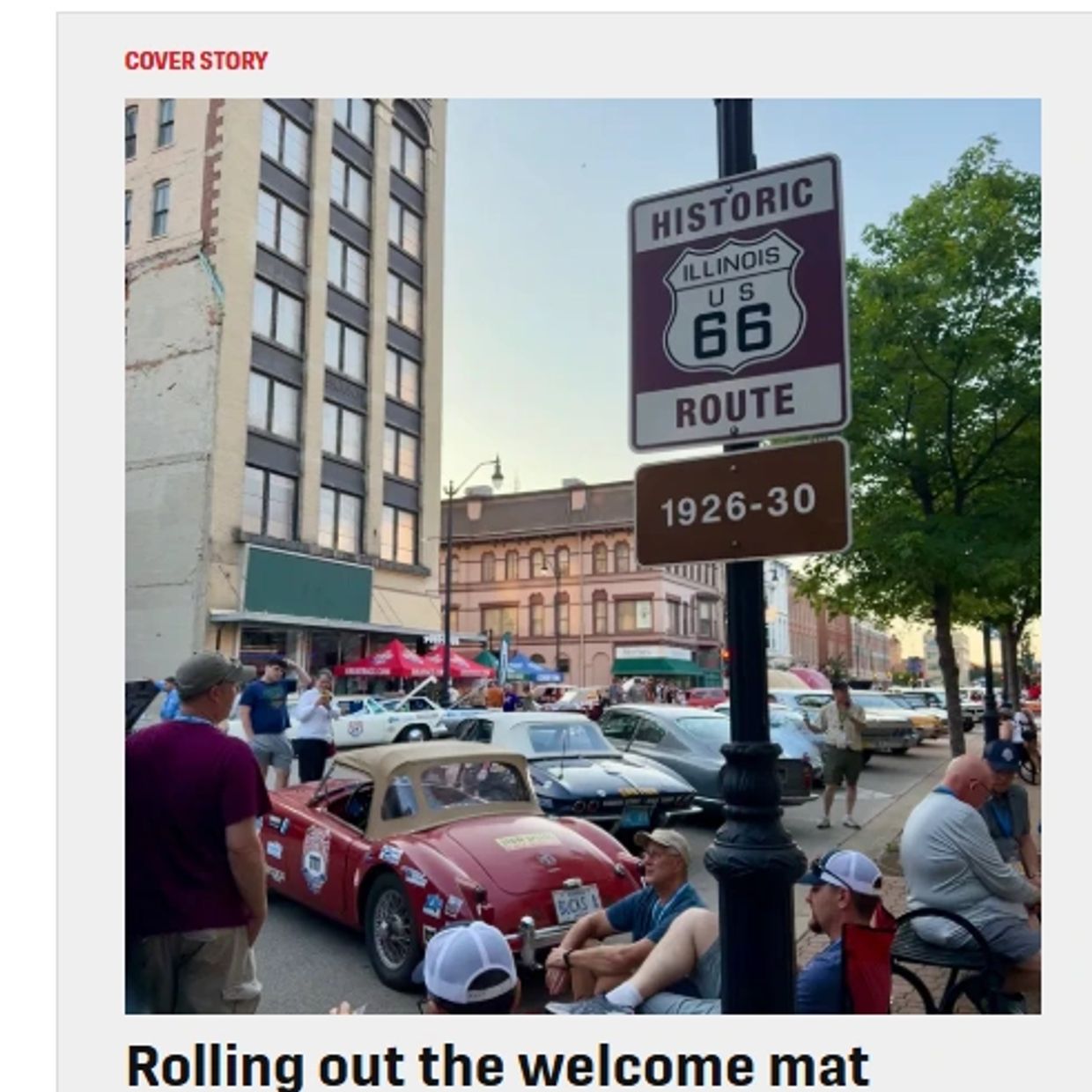 Classic cars and people gathered along Historic Route 66 in Illinois.