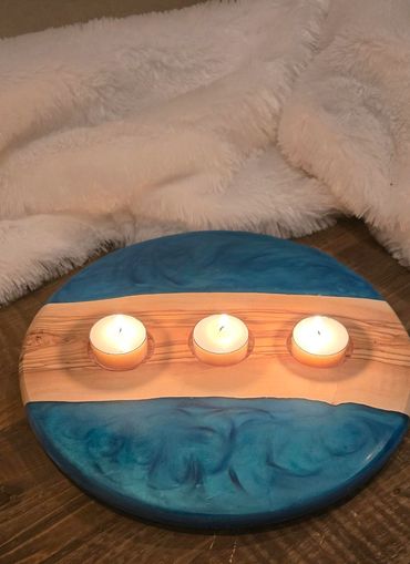Round olive wood candle holder with a blue resin top and three tea light candle inlays