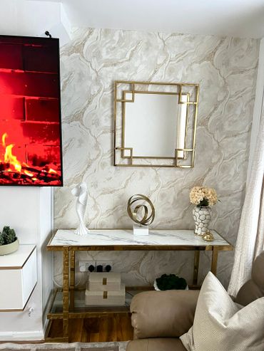 Elegant living room corner with gold accents and modern decor.
