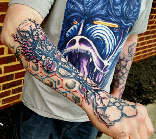 Geometric tattoo bee , hexagon honeycomb spiral on hand under organic tree
