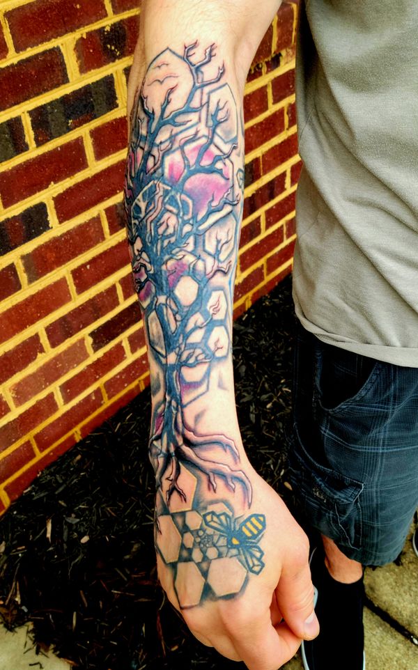 Geometric tattoo bee , hexagon honeycomb spiral on hand under organic tree