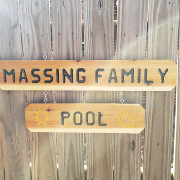 Custom created sign for display around the pool with hand drawn Sun's on either side